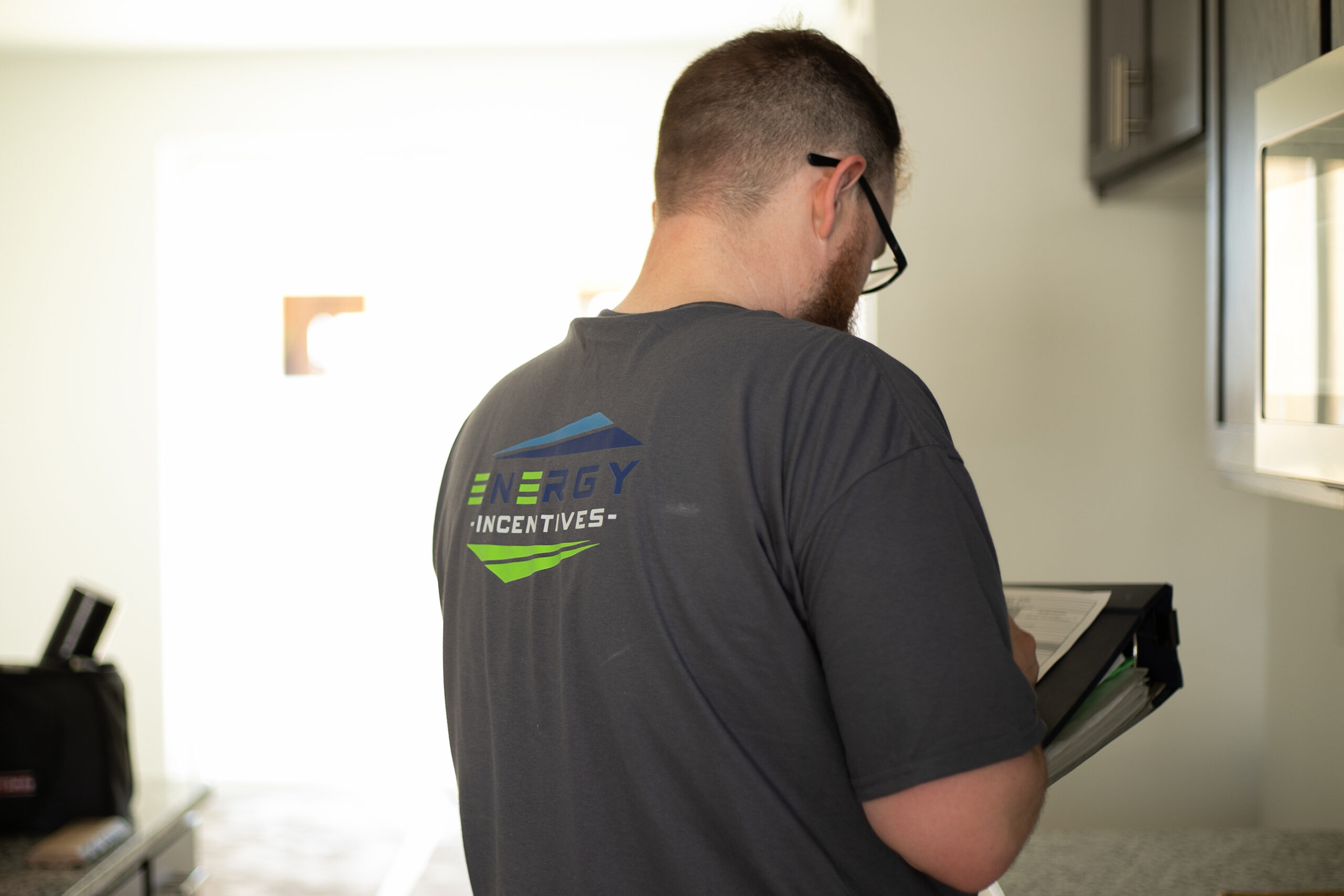 A professional conducting a home energy audit to find air leaks.